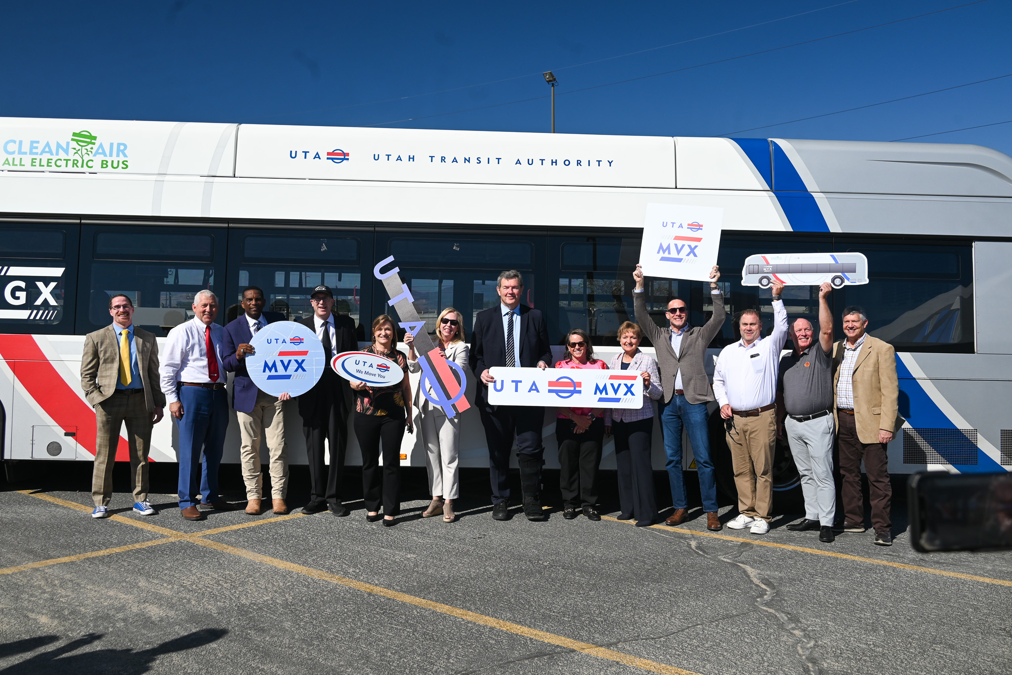 A group of people holding a sign.