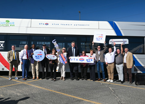 A group of people holding a sign.