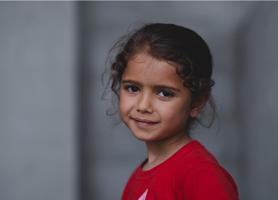 A young girl smiling.