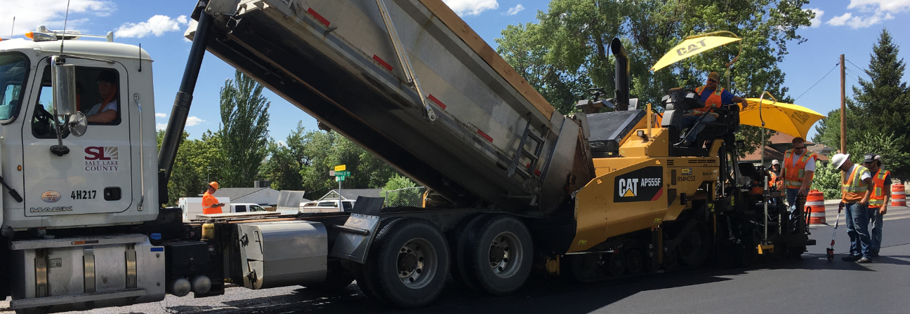 A group of men working on a large truck.