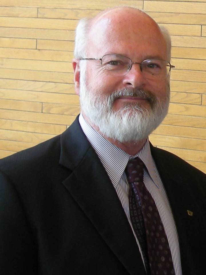 A man with a white beard and glasses.