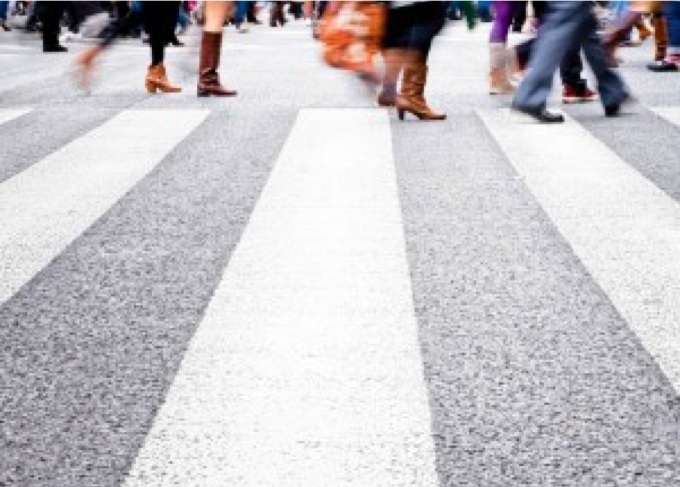A group of people walking on a street.