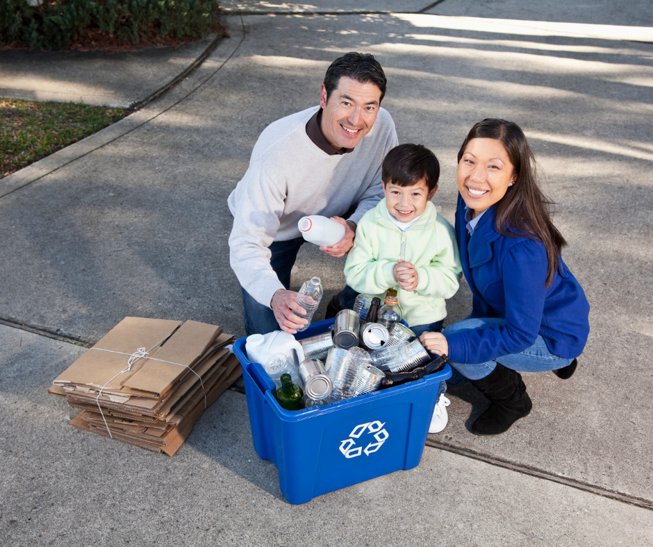 A man and woman with a couple children sitting in a blue shopping cart.