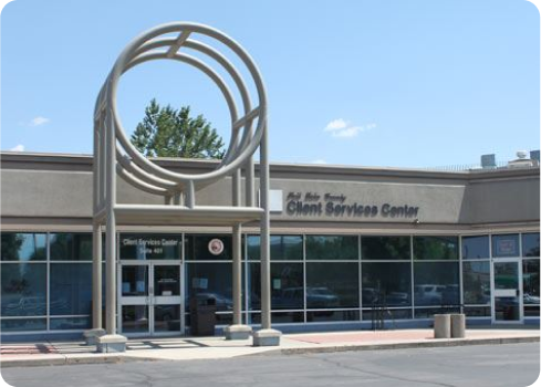 A building with a large sculpture in front of it.