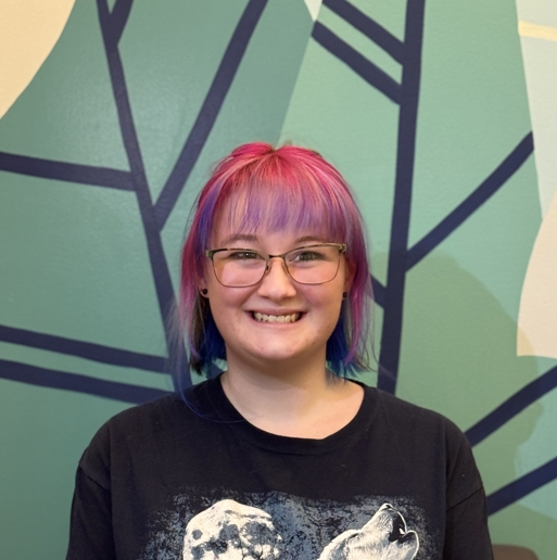 A woman with pink hair.