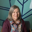 A woman smiling for the camera.