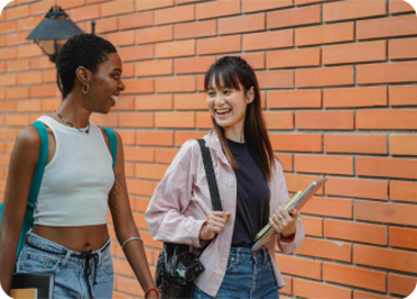 A couple of women looking at a paper.