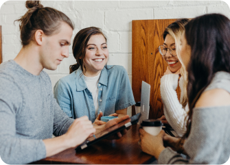 A group of people sitting around a table.