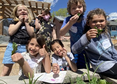 A group of kids eating food.