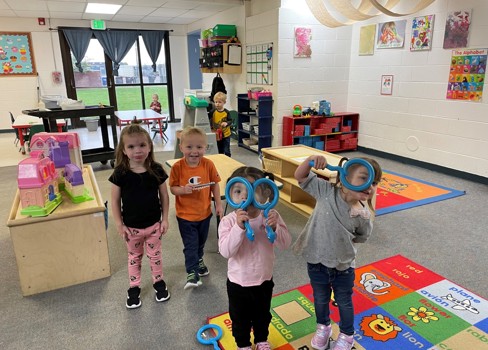 A group of children in a room with toys.