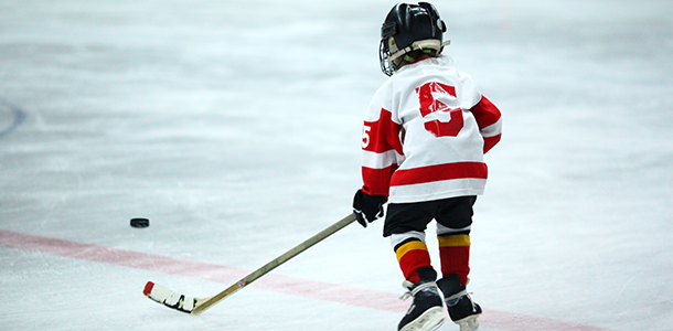 A kid playing hockey.