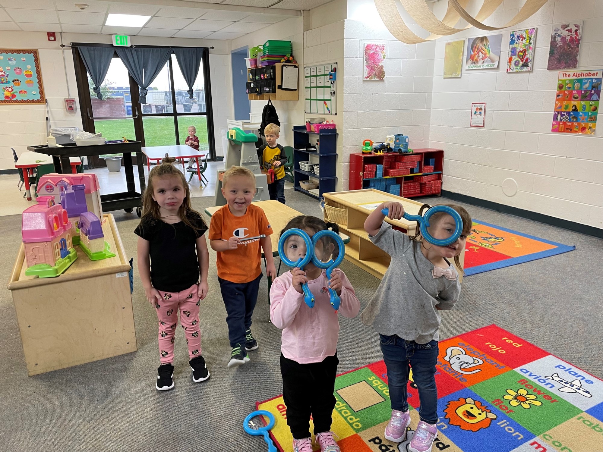 A group of children in a room with toys.
