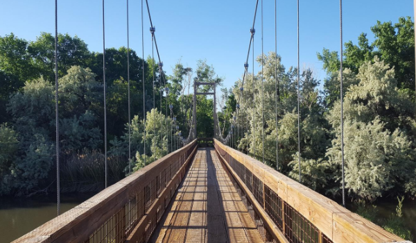 A long wooden bridge over water.