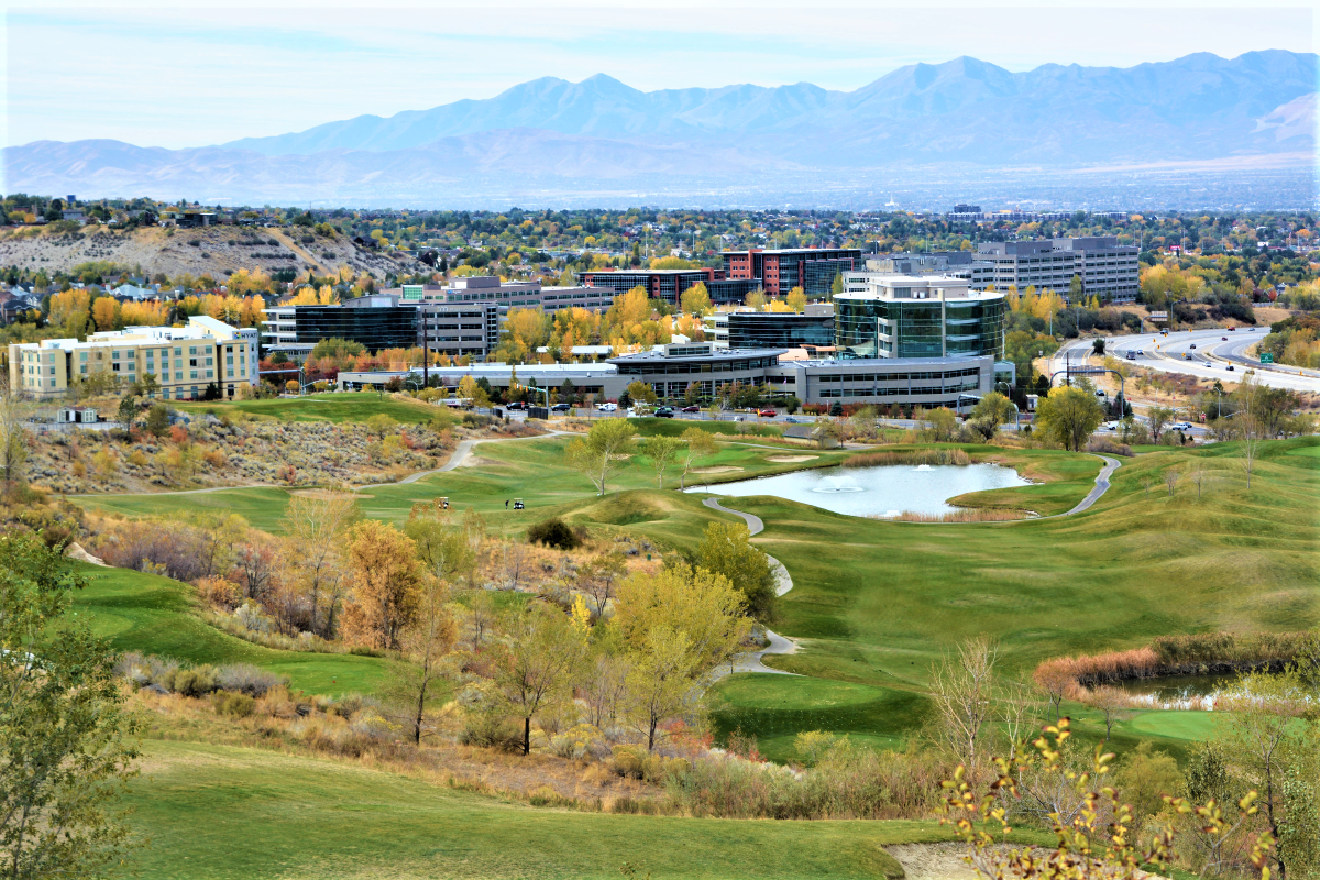 A large building with a pond in front of it.