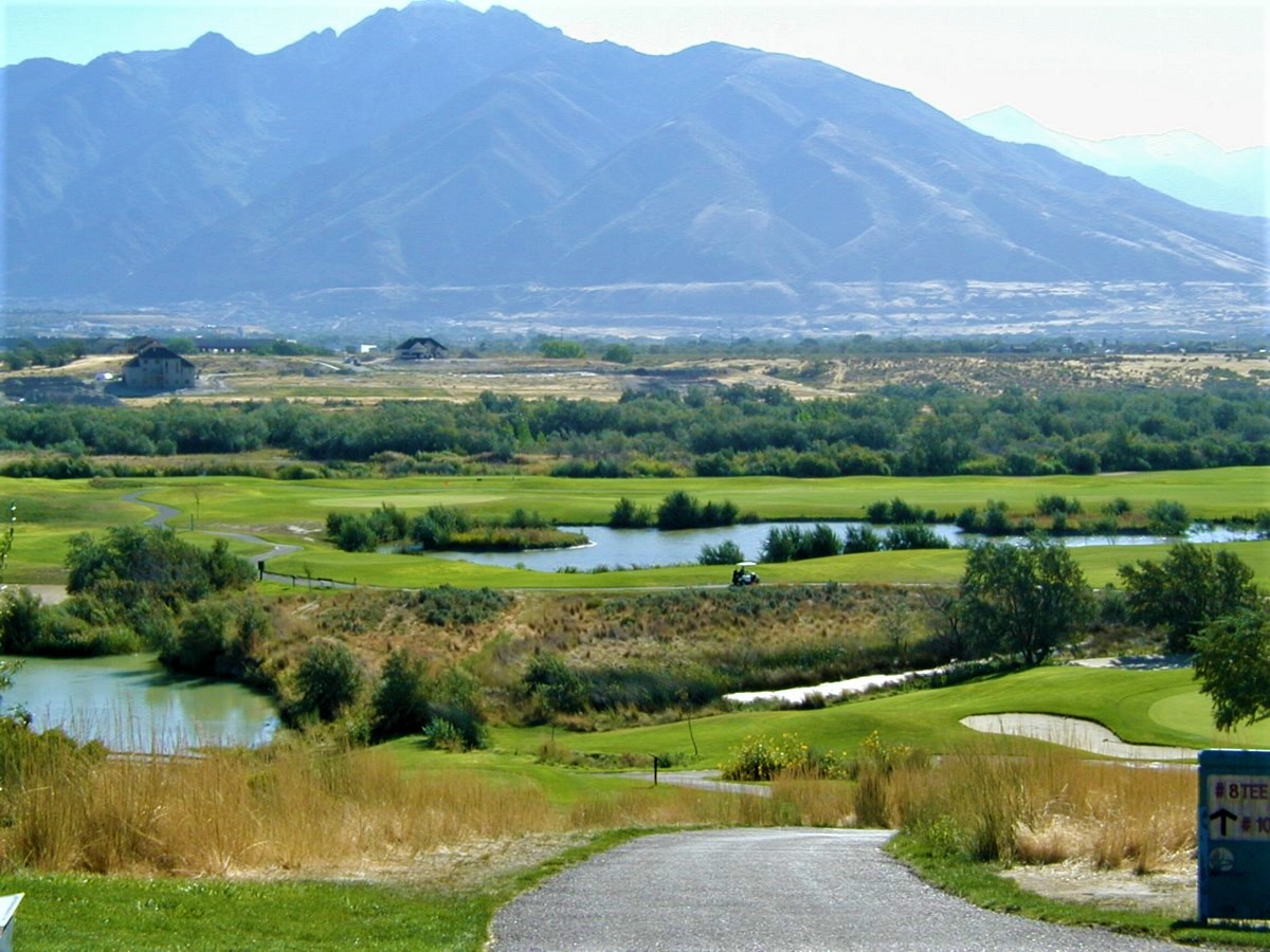 A lake in a grassy area.