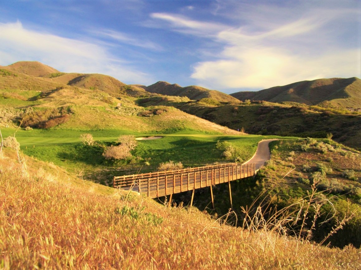 A bridge over a grassy valley.